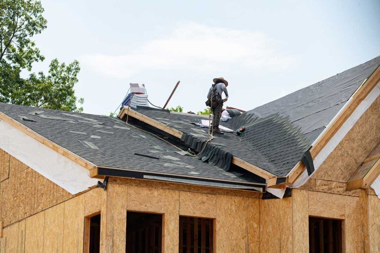 Light-colored reflective roof on a suburban home under bright summer sunlight