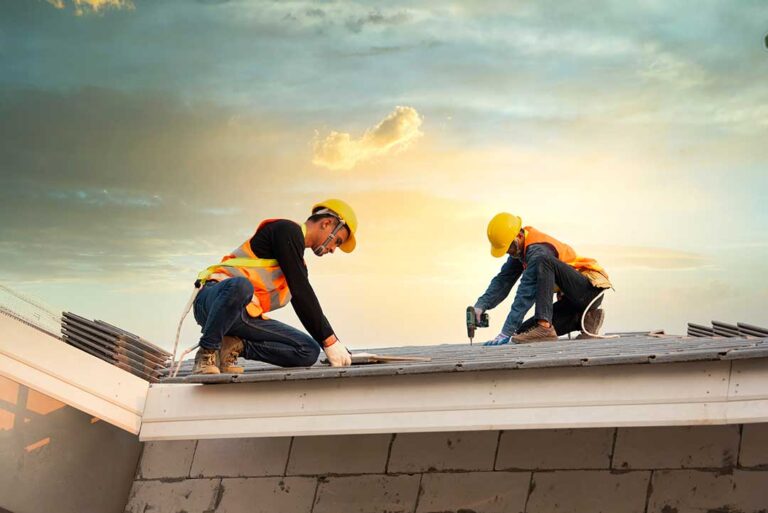 Homeowner inspecting a roof edge from a secured ladder on a clear, dry day.